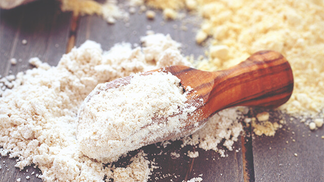 Chickpea flour in wooden scoop