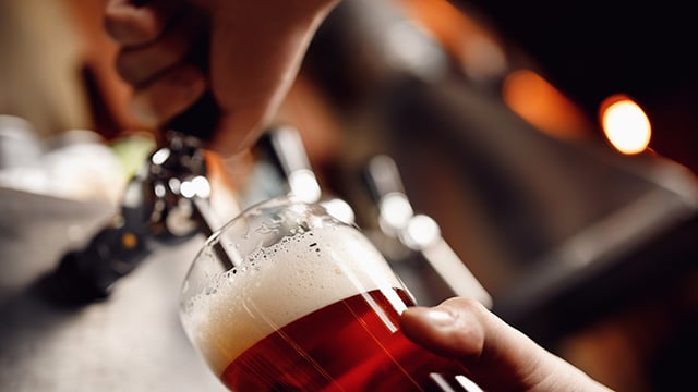 Close up of beer poured from tap